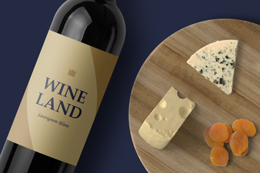 A Bottle of Red Wine and a Cheese Board Closeup View