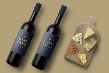 Two Bottles of Red Wine Next to a Cheese Board