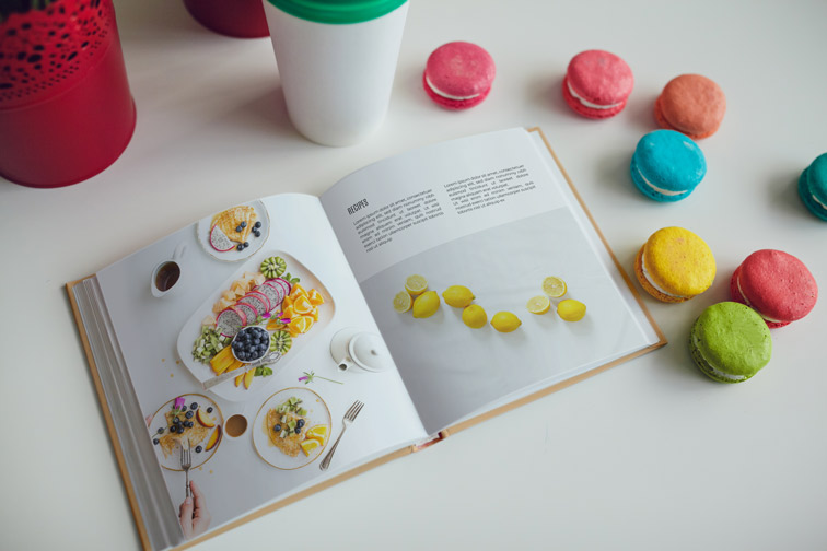 Open Recipe Book with Macarons