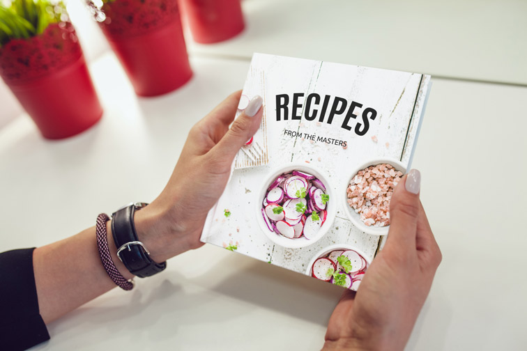 Hands Holding a Recipe Book