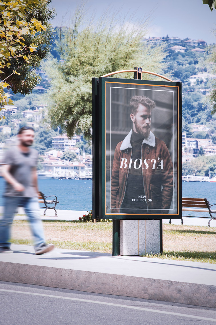 Man Walking Next to a Billboard