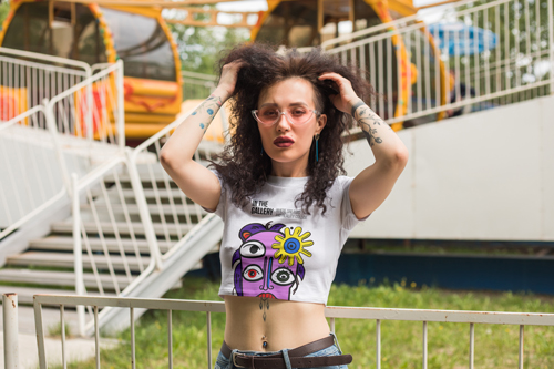 Woman in a Baby Tee Touching Her Hair