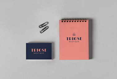 Notepad with a Business Card and Paper Clips