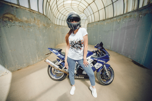 Woman in a T-shirt in Front of Motorbike