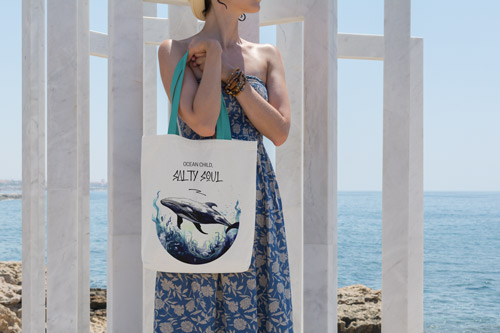 Woman Standing by the Sea with a Bag