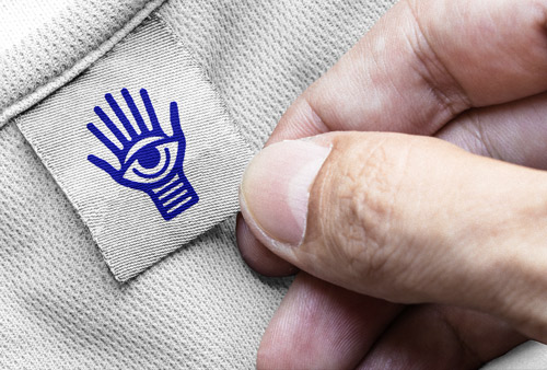 Hand Holding a Clothing Label